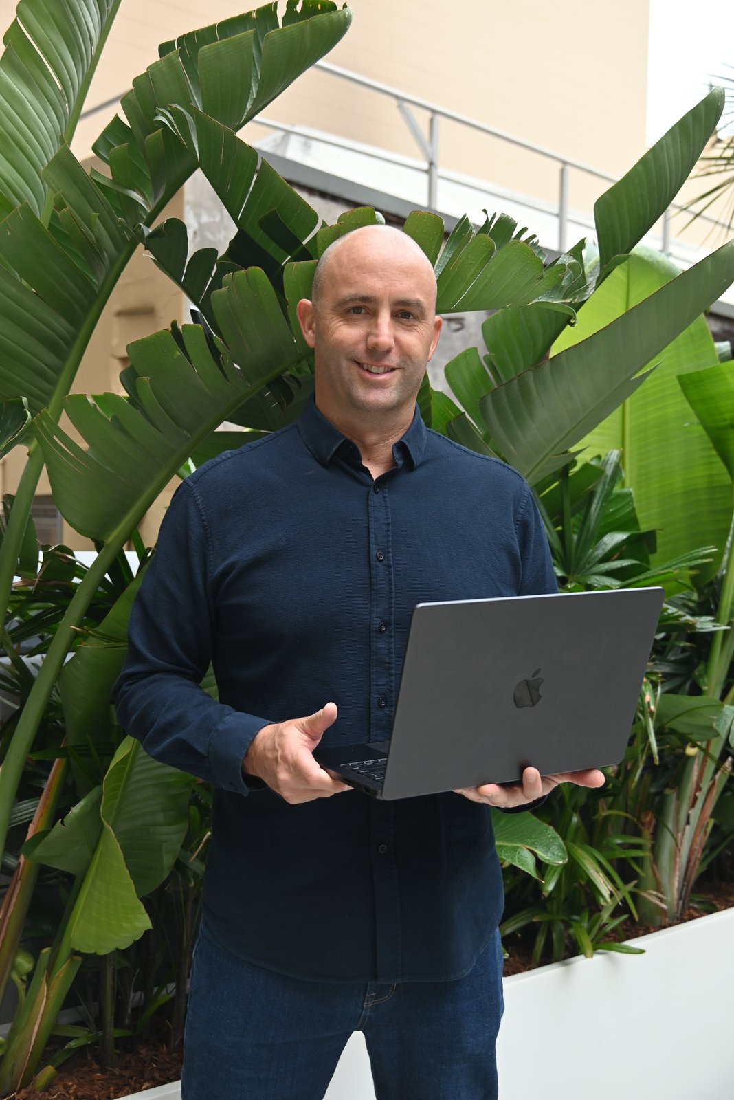 Mat Tower holding a laptop